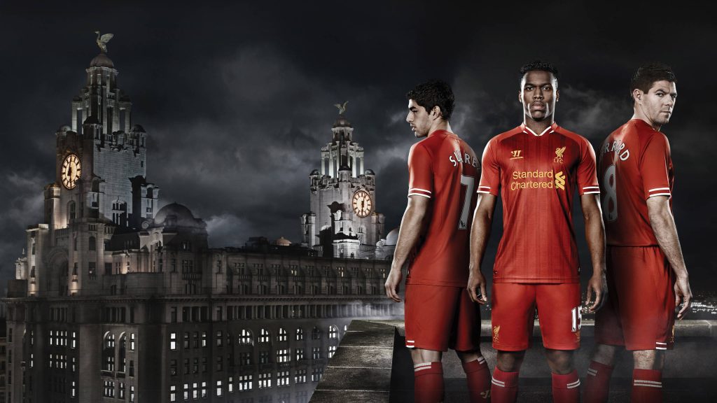 Liverpool FC legends Suarez Sturridge Gerrard in red kits at night with historic Liver Building background Wallpaper