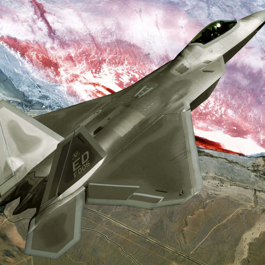 Lockheed Martin F-22 Raptor fighter jet mid-flight showcasing stealth design and sleek lines Wallpaper