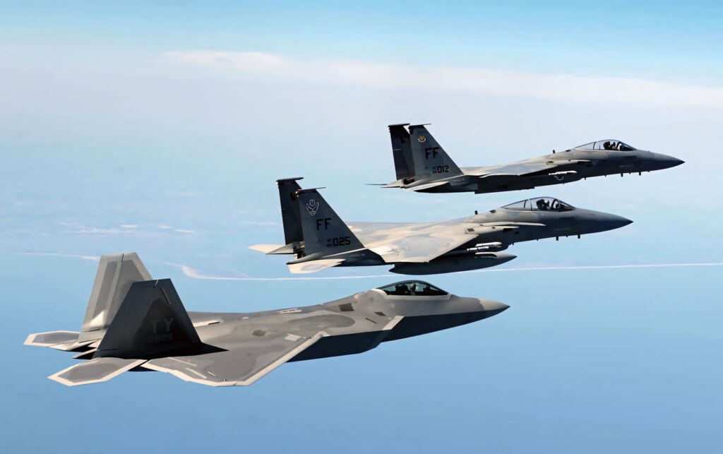 Lockheed Martin F-22 Raptor and two F-15 jets flying in formation under clear blue sky wallpaper