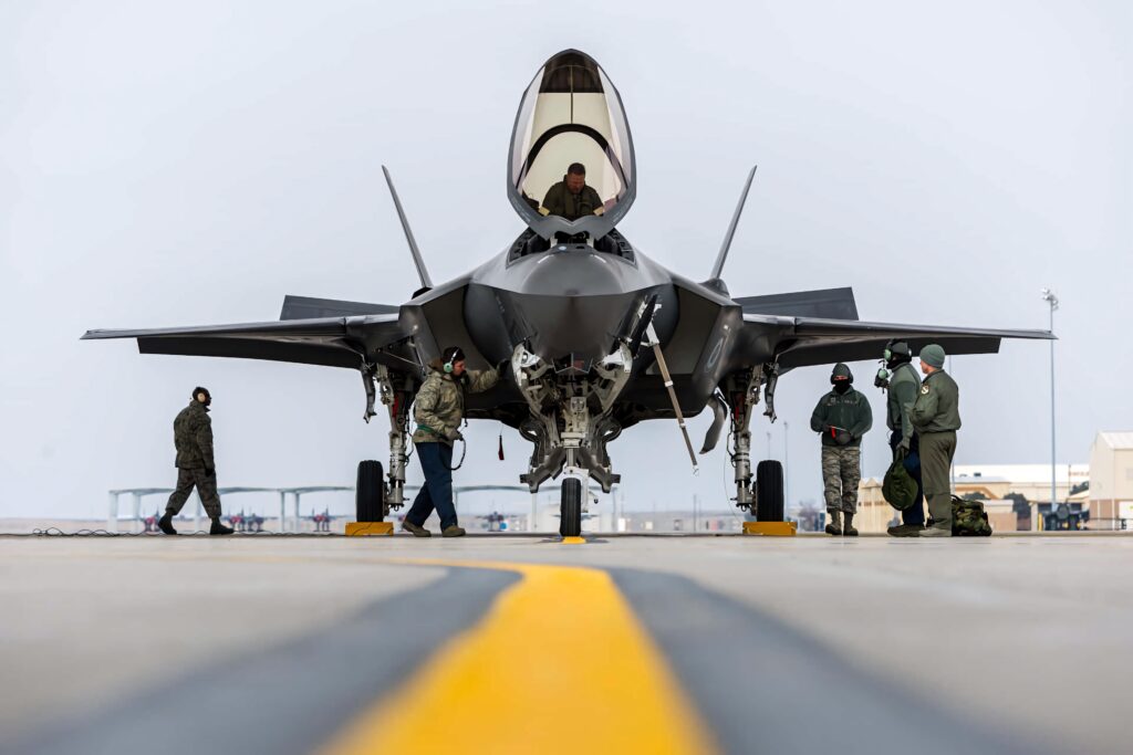 Lockheed Martin F-35 fighter jet on airstrip with crew highlighting advanced military technology Wallpaper