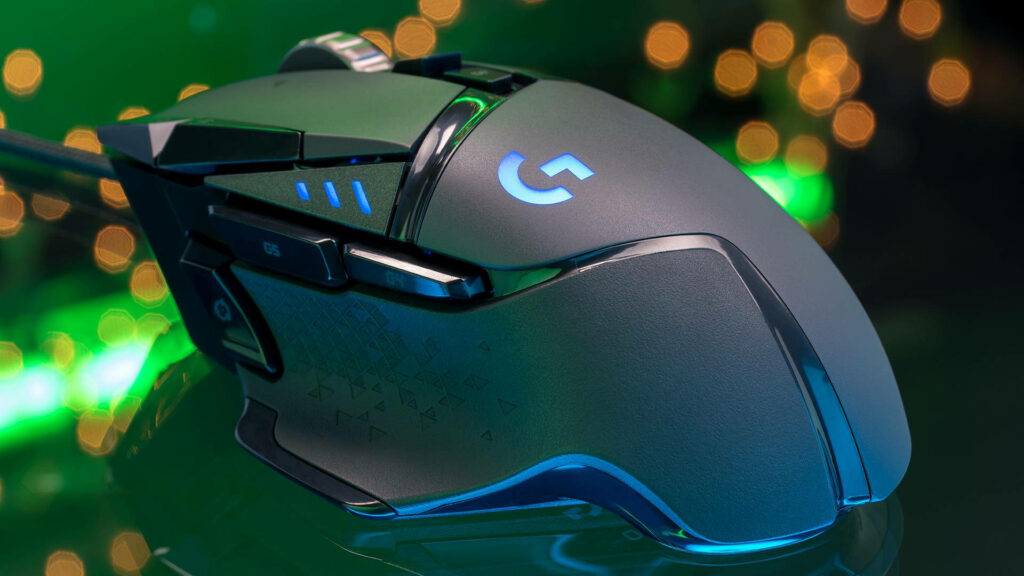 Logitech gaming mouse close-up with LED lights on vibrant green bokeh background high-tech design Wallpaper