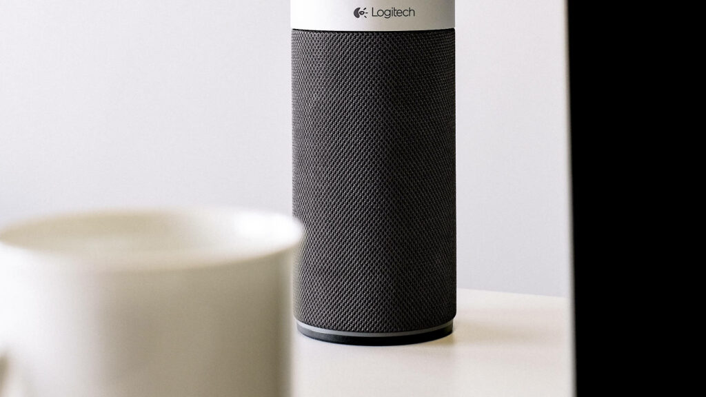 Logitech sleek speaker on modern desk showcasing advanced audio technology and communication design Wallpaper