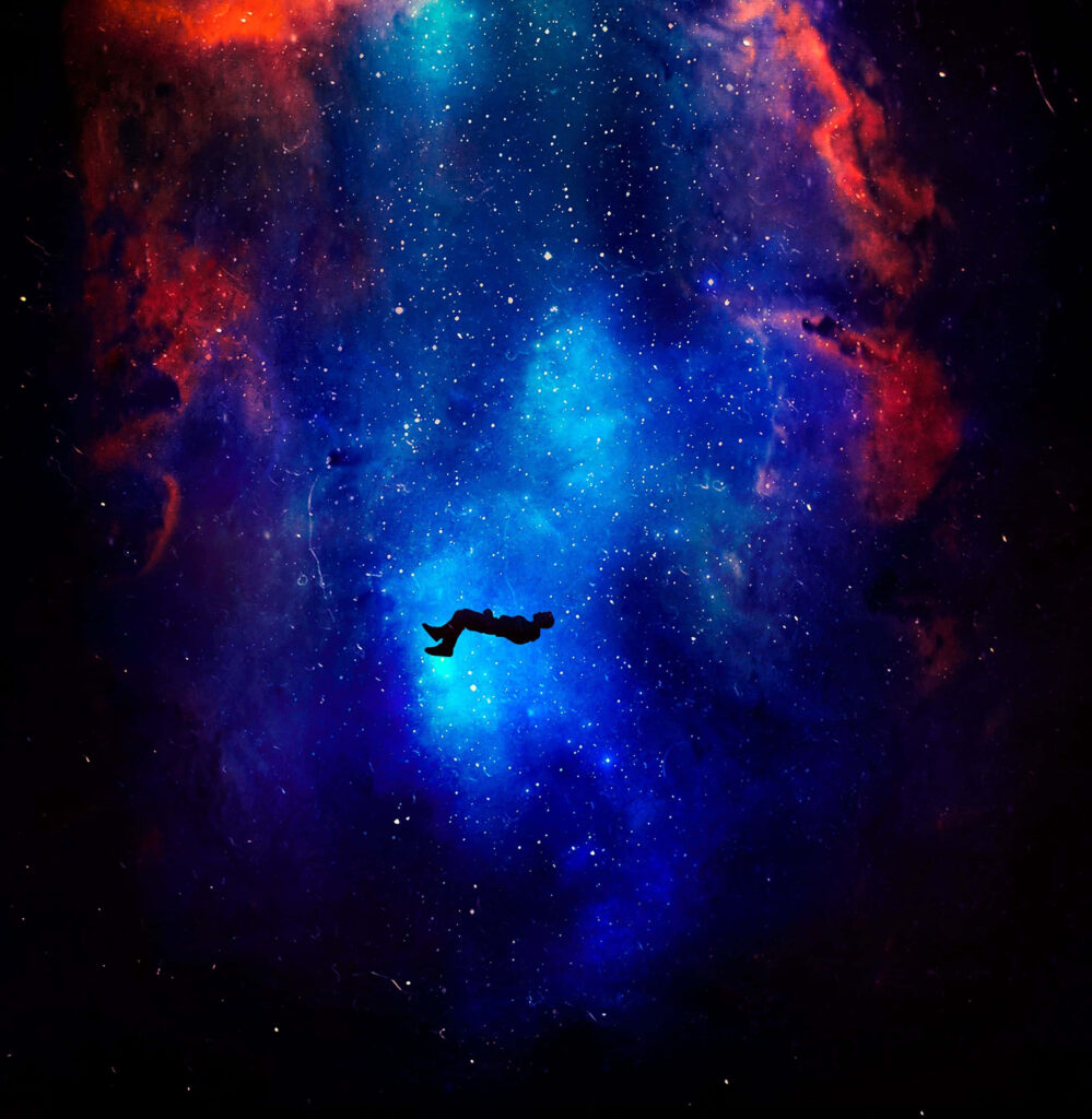 Colorful astronaut wallpaper with vivid nebulae in blue, red, and orange hues.