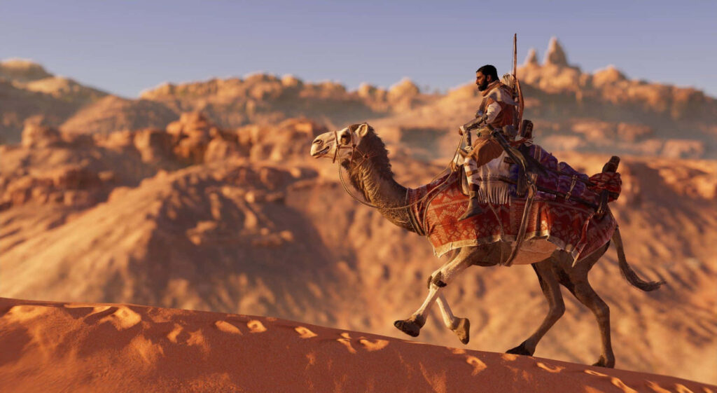 Lone camel with vibrant textiles stands in sunlit desert sands highlighting solitude and adventure Wallpaper