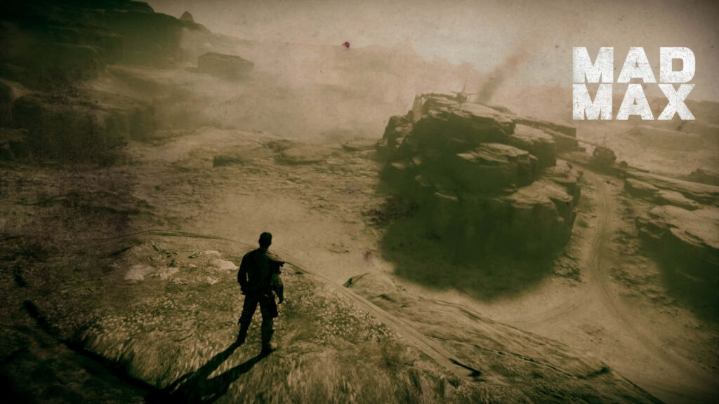 Lone figure on rocky ridge overlooking vast barren desert Mad Max inspired landscape wallpaper