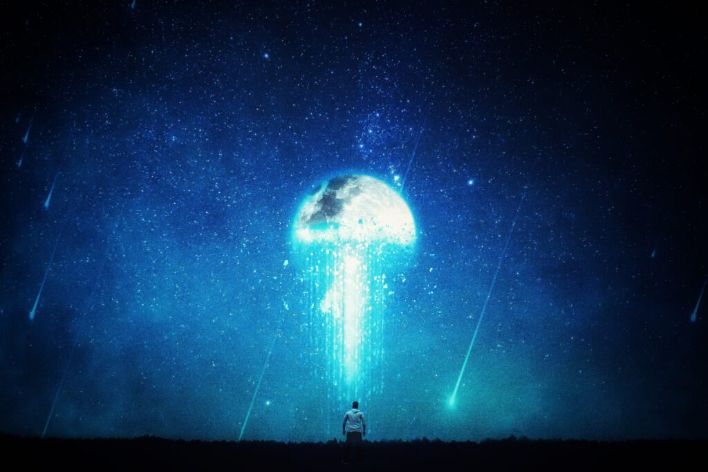 Man standing under luminous moon with cosmic blue starry sky and ethereal light beams background Wallpaper