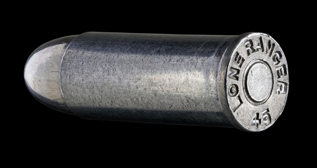 Detailed .45 caliber Lone Ranger 45 engraved bullet on black background with rugged metallic finish Wallpaper