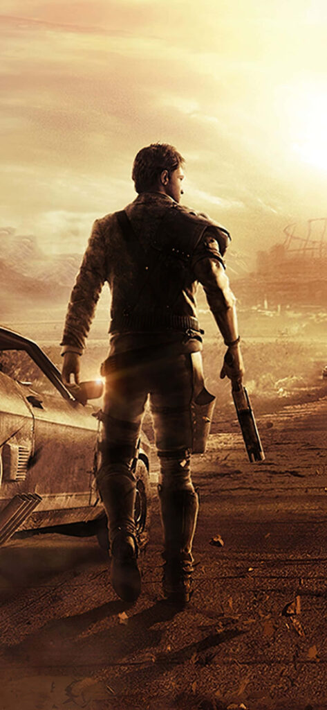 Lone warrior beside rugged car in sun-scorched wasteland Mad Max post-apocalyptic desert background Wallpaper