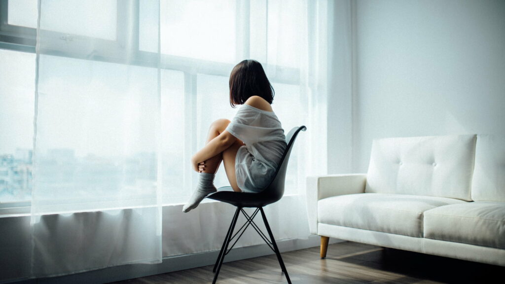 Solitude in Sadness: A Stunning HD Wallpaper of a Lonely Girl Sitting on a Chair