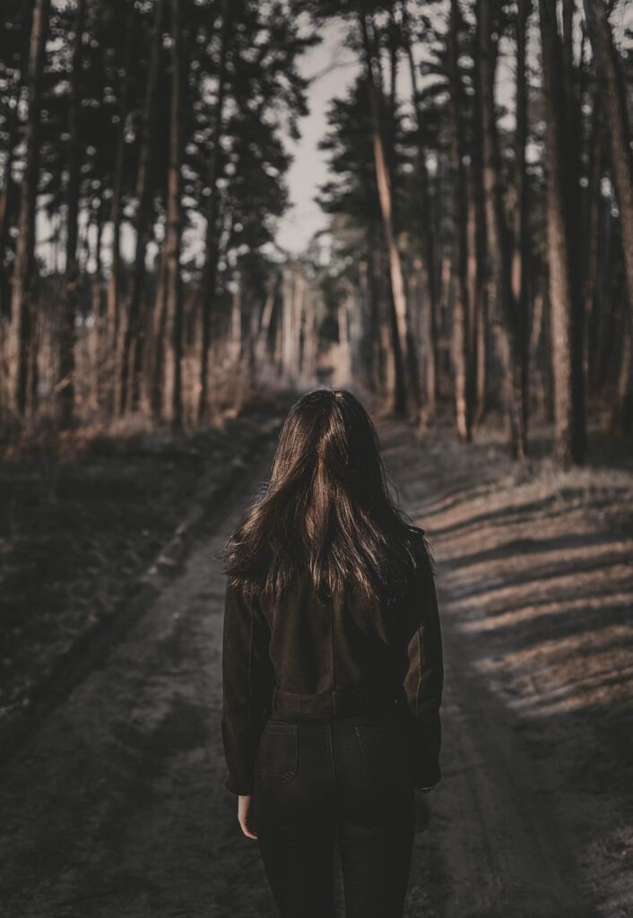 Lonely Forest Scene: Girl in Contemplation - Wallpaper Background