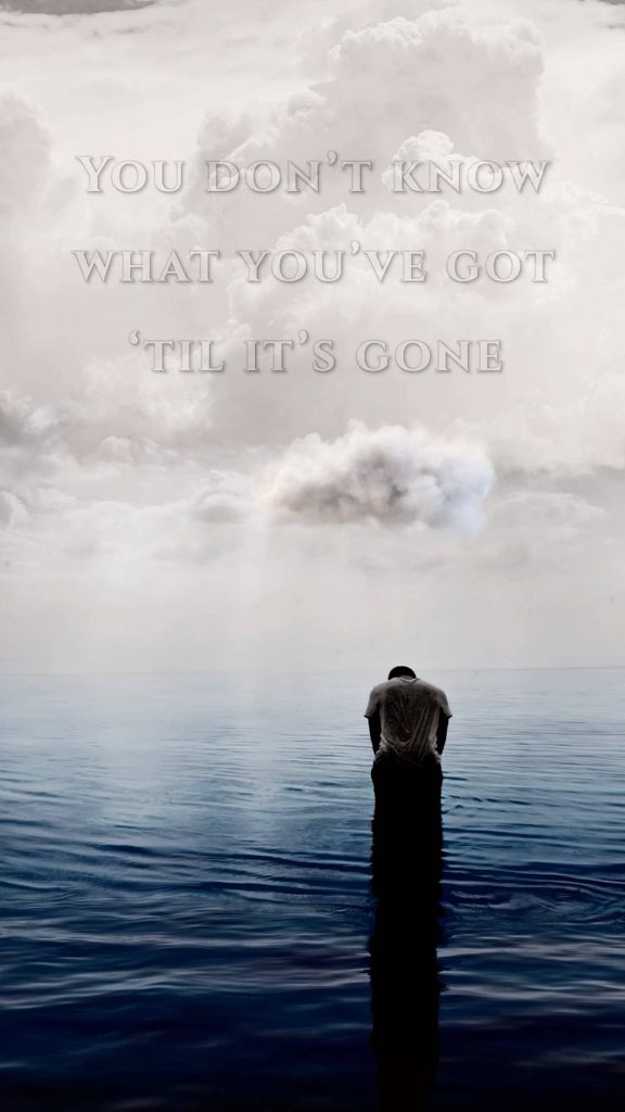 Lonely figure in calm ocean under overcast sky with sad quote reflective wallpaper background