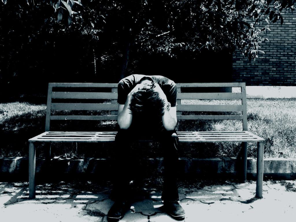 Solitary Melancholy: Emotionally Charged Wallpaper of a Cool Sad Boy Desperately Seeking Solace on a Lonely Bench
