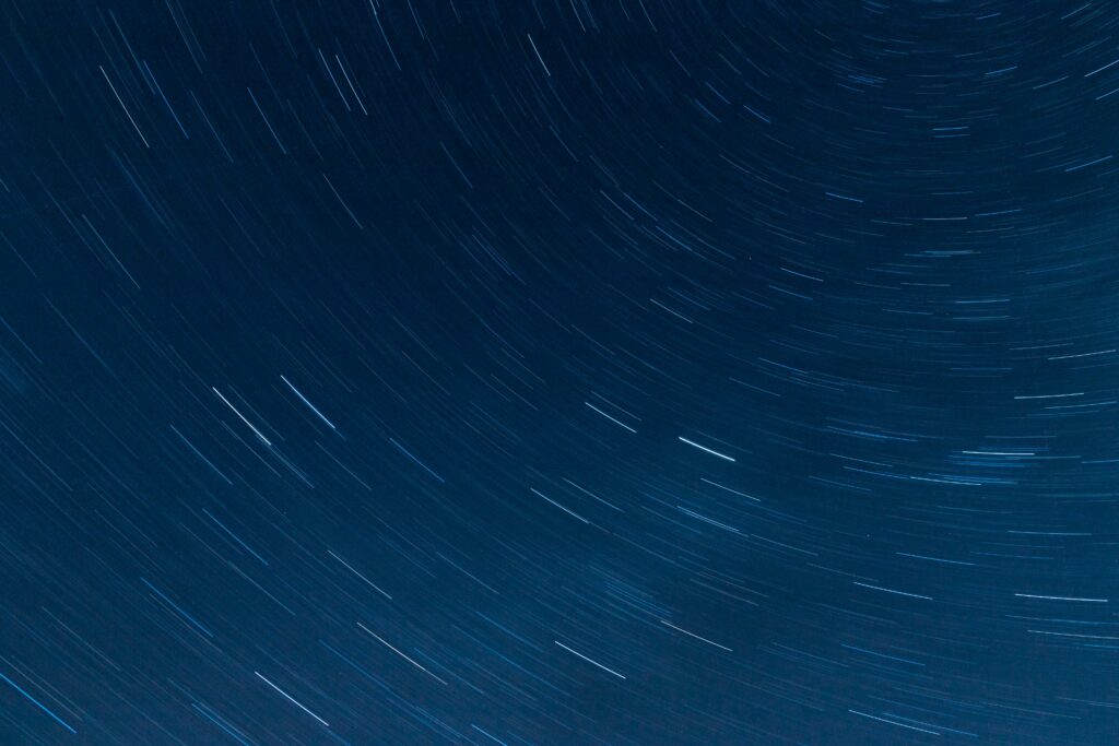 Dynamic Night Sky Wallpaper: Long-Exposure Star Trails Background