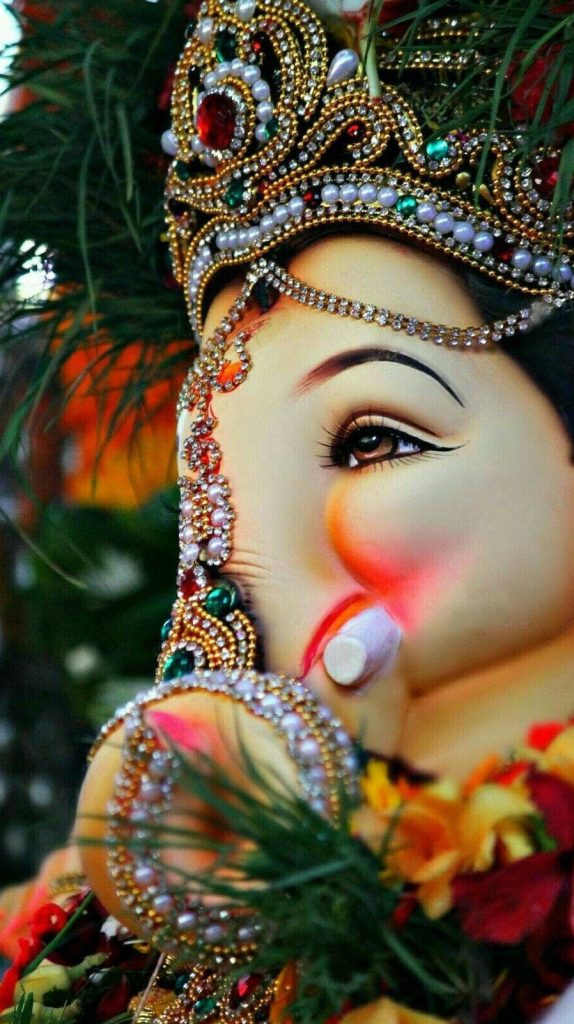 High-resolution Lord Ganesha portrait with gold jewelry pearls vibrant gemstones spiritual wallpaper