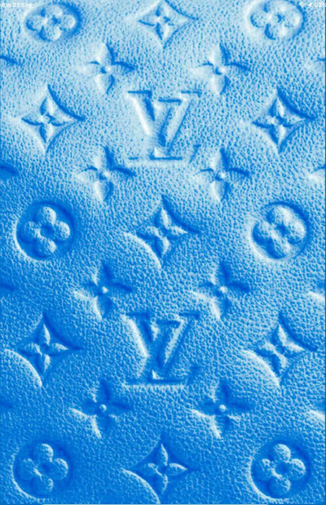 Louis Vuitton monogram pattern embossed on vibrant blue textured wallpaper background luxury style