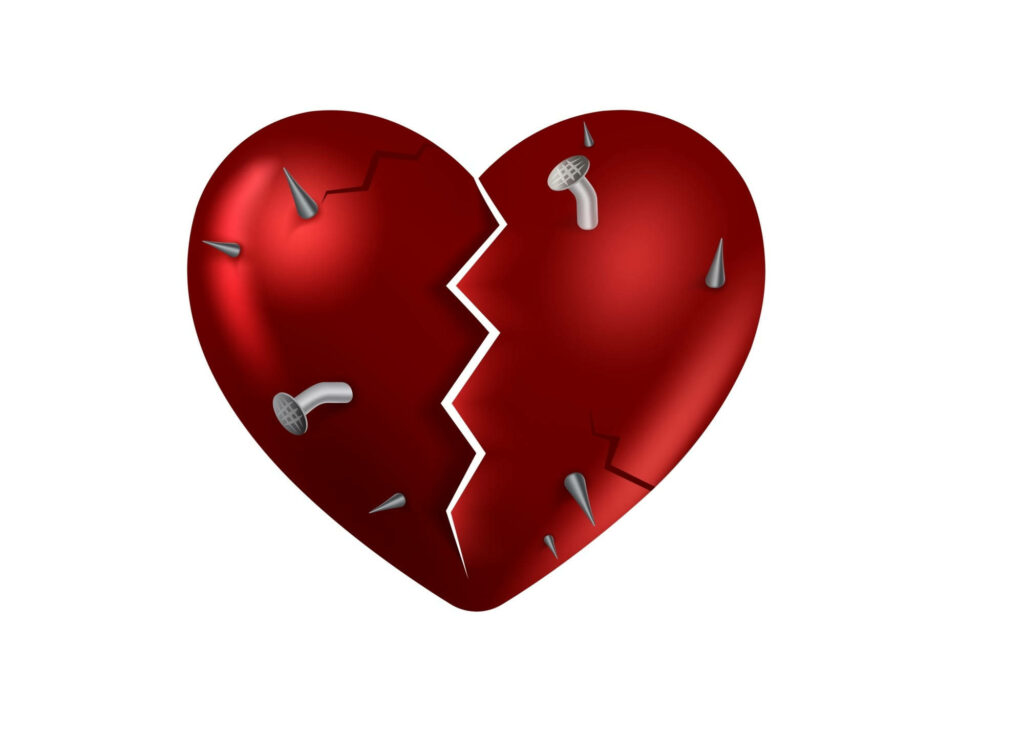 Vivid red broken heart with metallic nails on white background symbolizing deep heartbreak Wallpaper