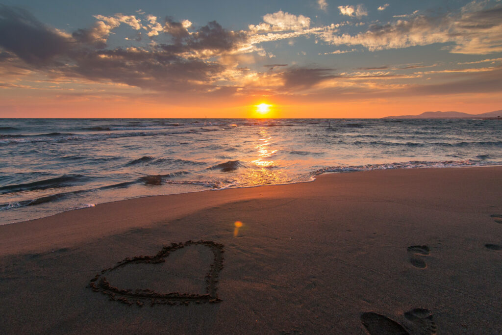 The Romantic Sands: A 4K Ultra HD Beach Background Capturing a Heart Drawn on the Shore Wallpaper