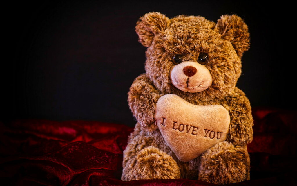 A Heartfelt Embrace: Captivating Love in Cuddly Teddy Bears Wallpaper