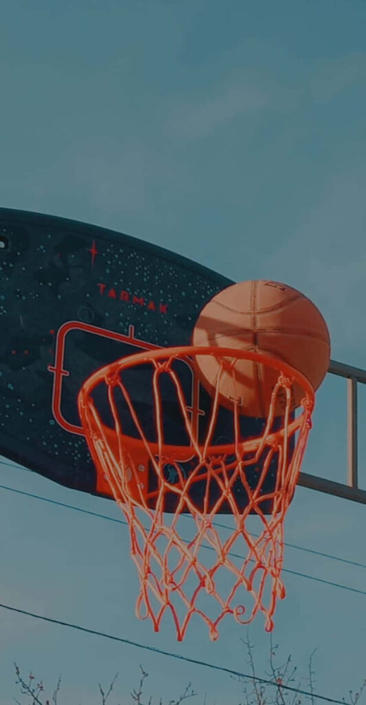 Low-Angle Basketball Hoop Shot Against Clear Sky - Wallpaper Background