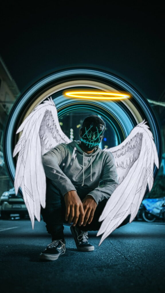 Neon hacker mask figure with yellow halo and white wings by blue portal on urban street wallpaper