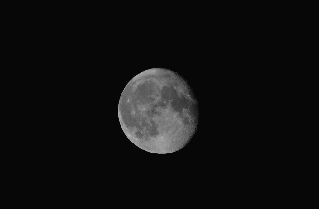 Luminous Full Moon Minimalist Wallpaper for a Dark Sky Background