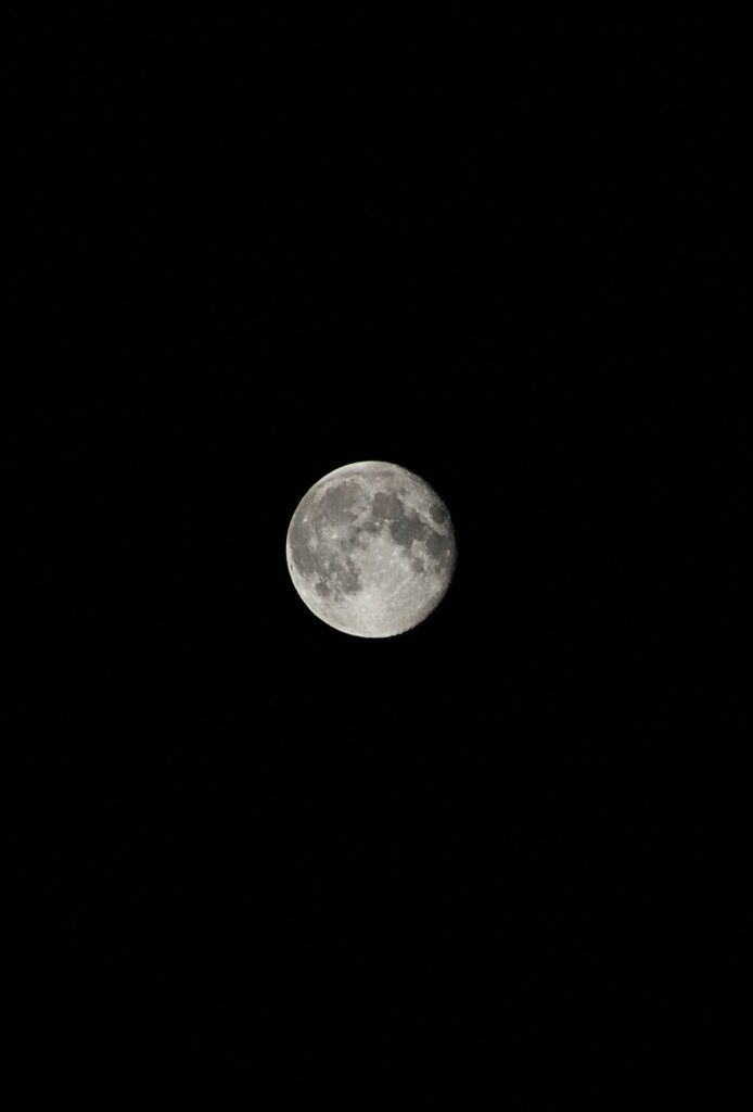 Luminous Full Moon Wallpaper: Stunning Contrast on Black Background