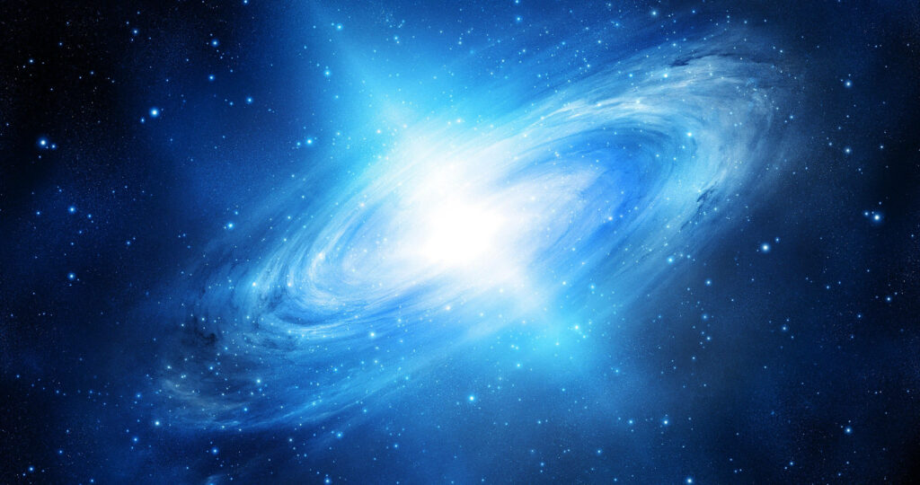 Vibrant 4K navy blue galaxy wallpaper with luminous core, cosmic dust, and twinkling stars.