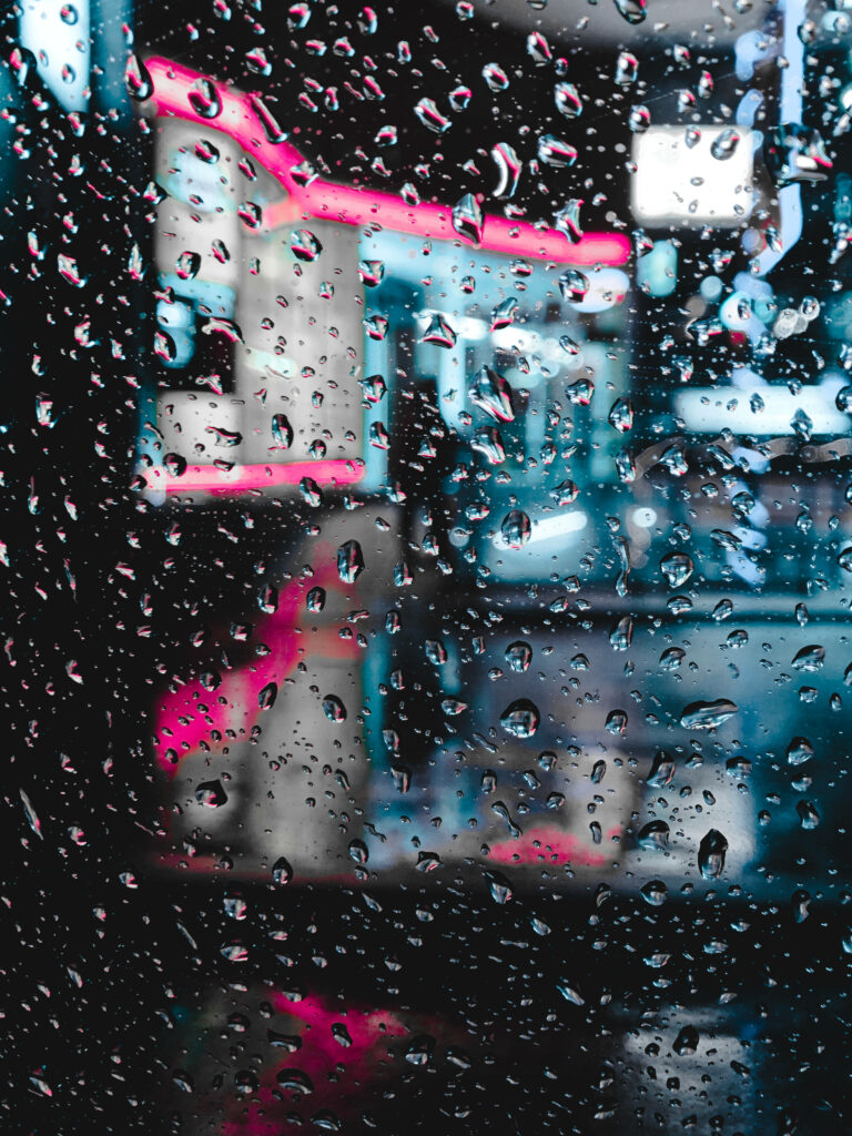 Glimmers of the Night: Neon Illuminations on an iPhone's Dark Backdrop Wallpaper