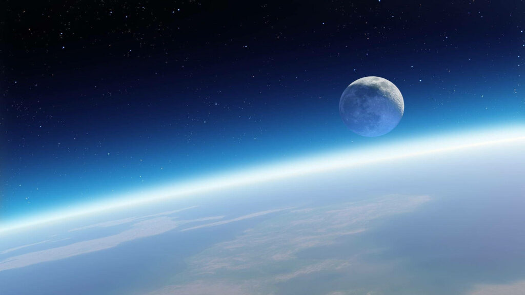 Moon above Earth's glowing horizon with stars deep space wallpaper high resolution view