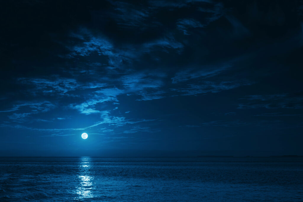 Majestic Lunar Glow: Mesmerizing Night Aesthetic by the Ocean Wallpaper