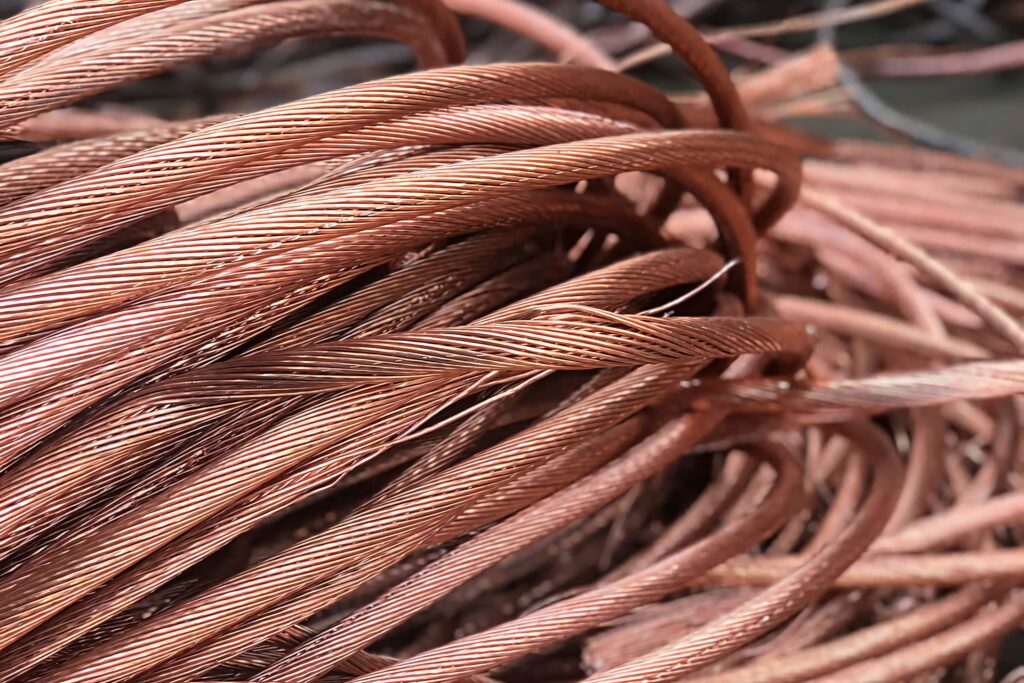 Close-up of intertwined copper wires showing metallic texture and rich reddish brown color background Wallpaper