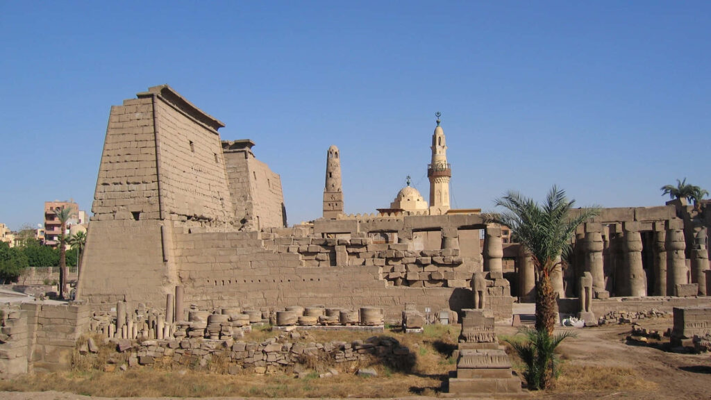 Luxor Temple ancient sandstone ruins grand columns statues clear sky Islamic architecture background Wallpaper