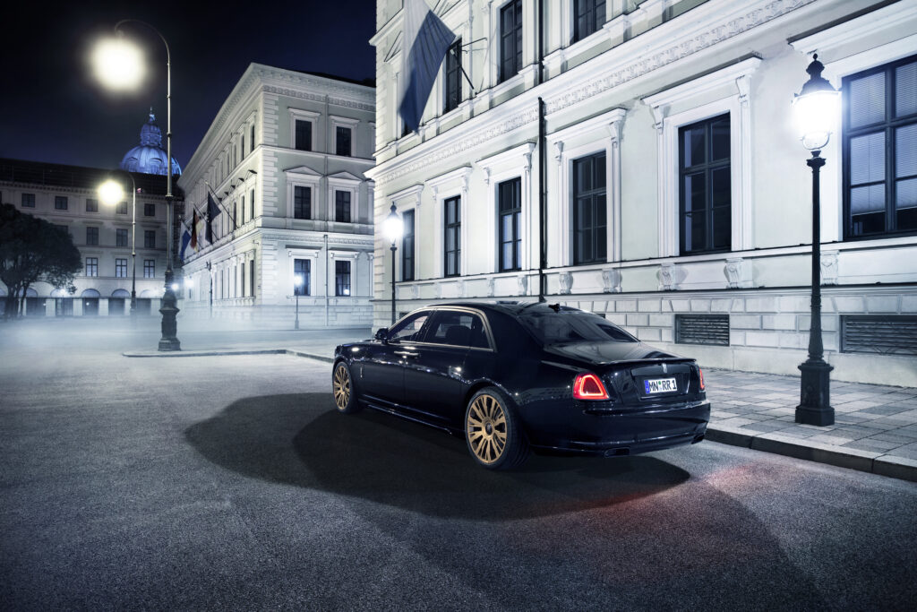 Luxurious 2015 Rolls-Royce Ghost: Rear View on Elegant Street Wallpaper