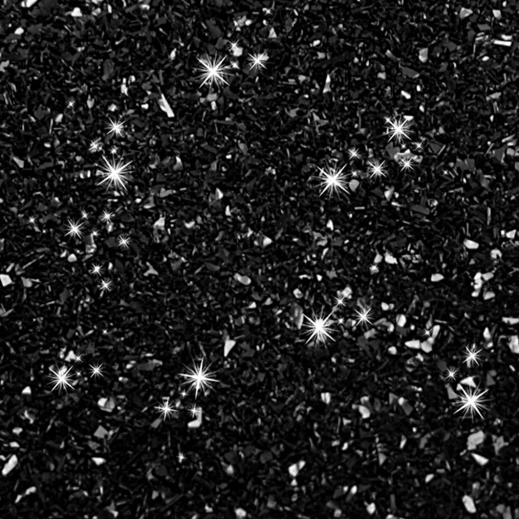 Black glitter textured wallpaper with crushed mineral look and white starburst reflections