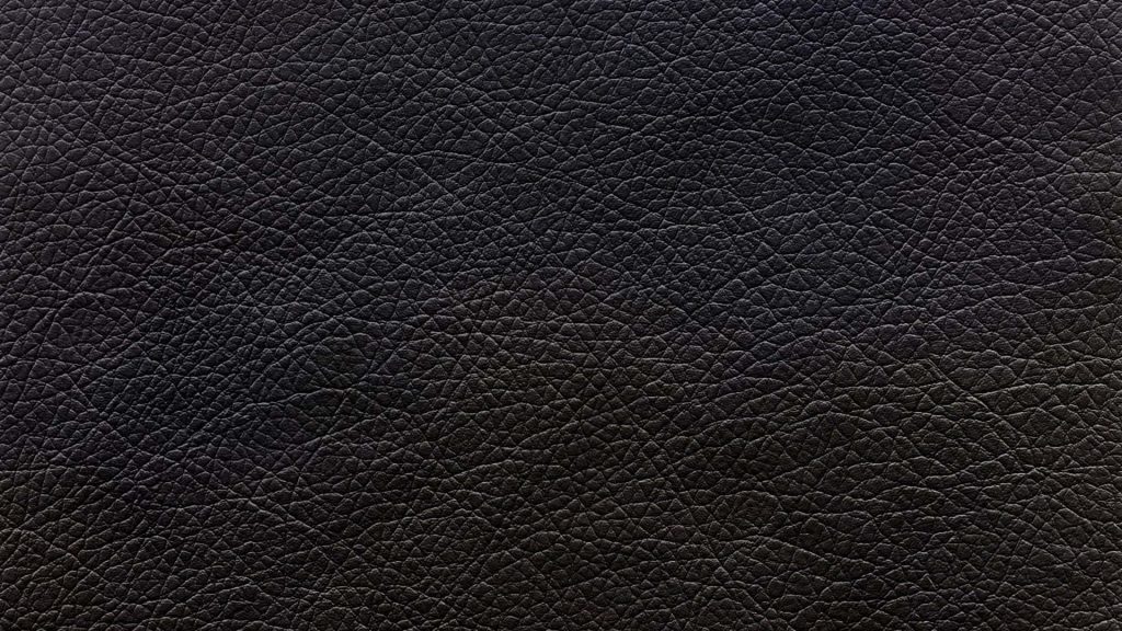 High-resolution black leather wallpaper with detailed grain texture for a sleek desktop background