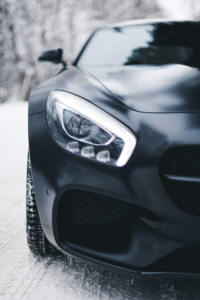 Stunning Black Mercedes-Benz Headlight Wallpaper in Snowy Background