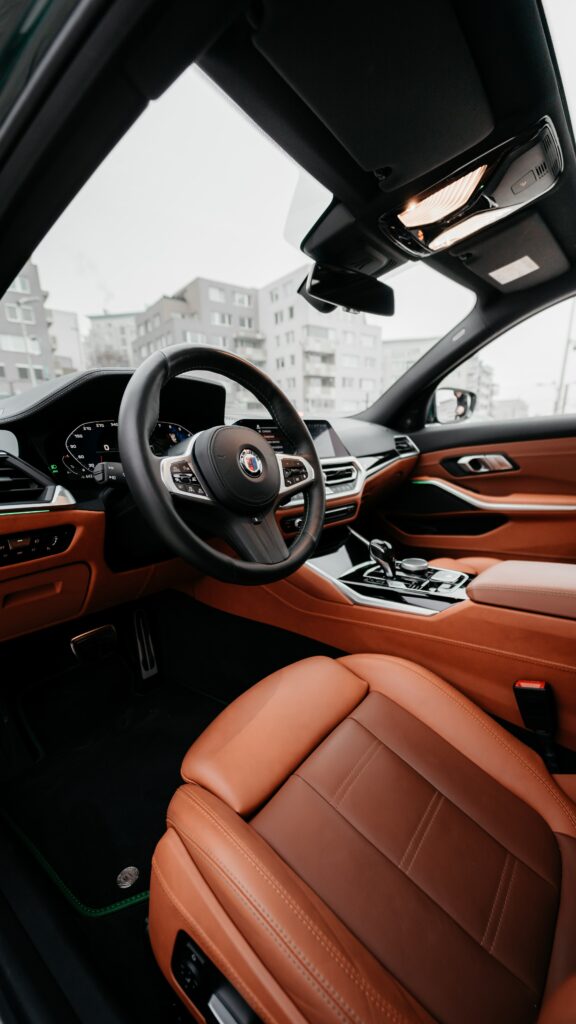 Luxurious Car Interior Wallpaper: Sleek Steering Wheel & Spacious Cabin