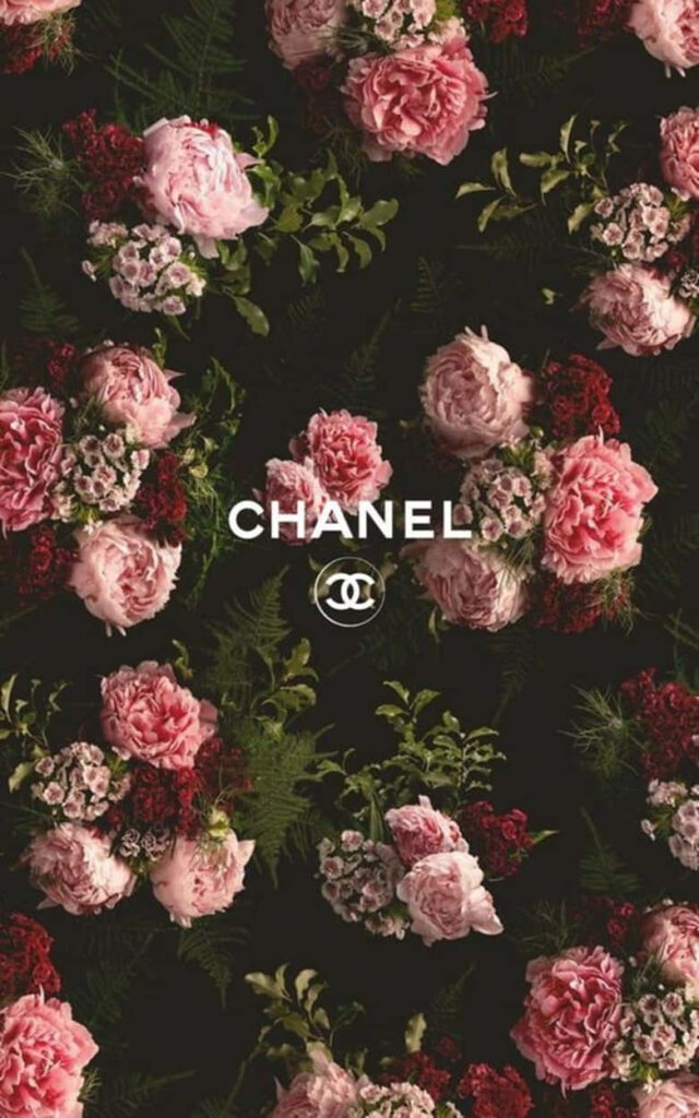 Luxurious Chanel wallpaper with pink red roses green leaves dark background and iconic logo center