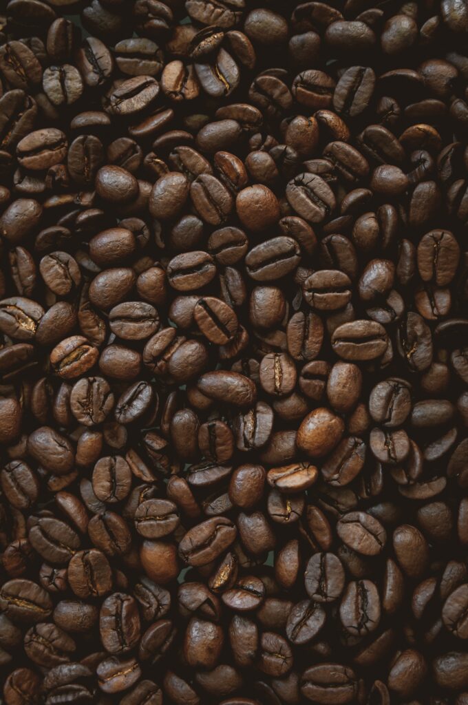 Rich Coffee Beans Wallpaper: Glossy Texture & Earthy Tones Background