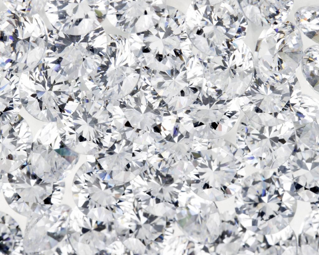 Close-up of brilliant-cut diamonds sparkling with sharp facets in high-resolution wallpaper design