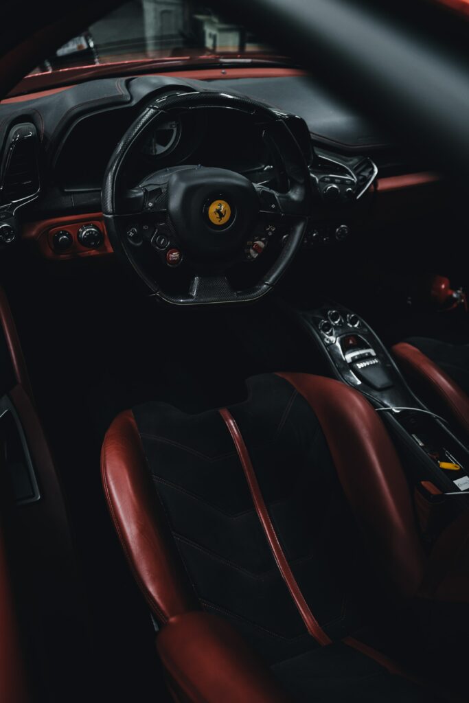 Luxurious Ferrari Interior Wallpaper: Sleek Steering Wheel & Elegance