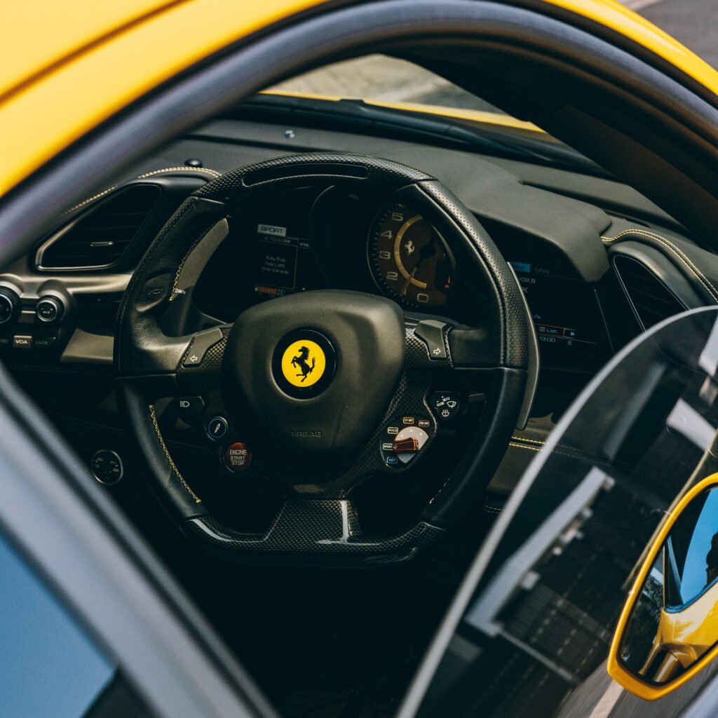Luxurious Ferrari Interior Wallpaper: Steering Wheel & Speedometer