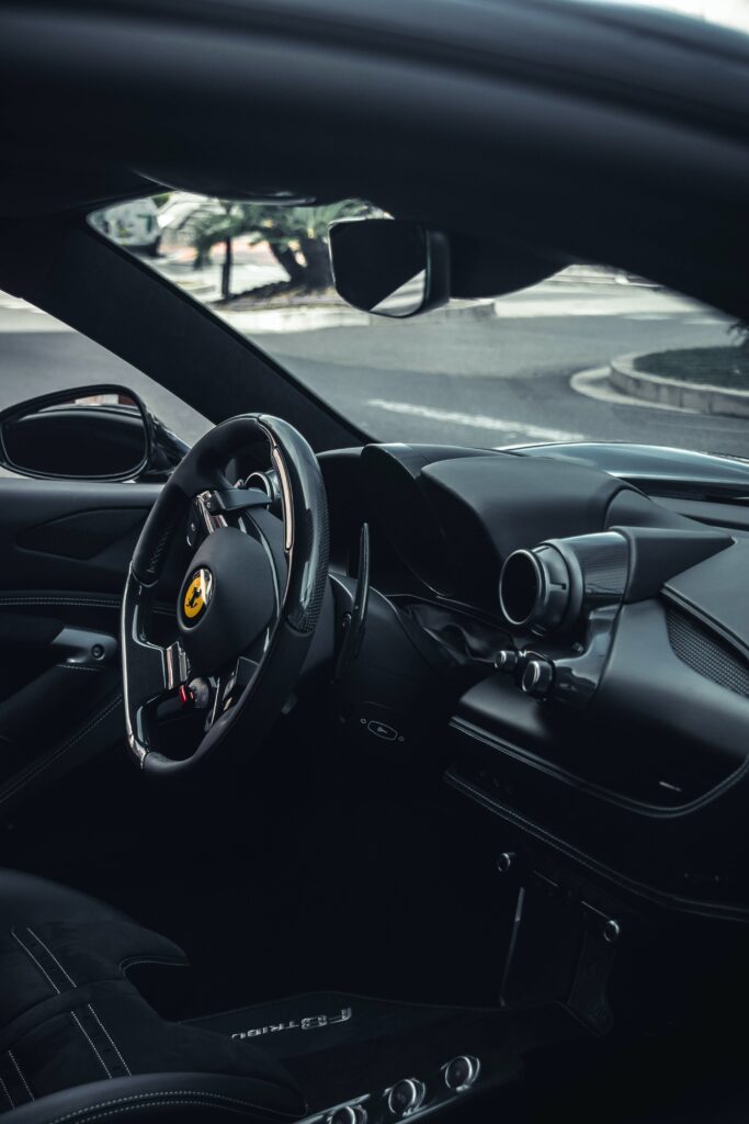 Luxurious Ferrari Interior: Sleek Steering Wheel & Dashboard Design Wallpaper