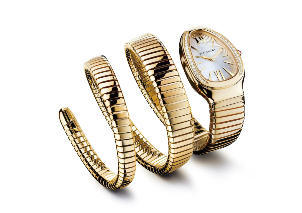 Luxurious gold Bvlgari serpent watch wallpaper with polished links and elegant white dial background