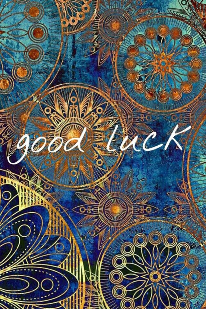 Intricate gold mandala on deep blue teal background with elegant white good luck text wallpaper