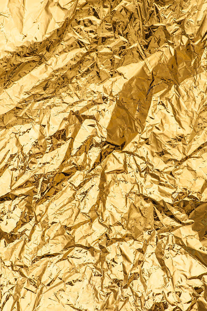 Luxurious Gold Metallic Wallpaper: Vibrant Crumpled Texture Background