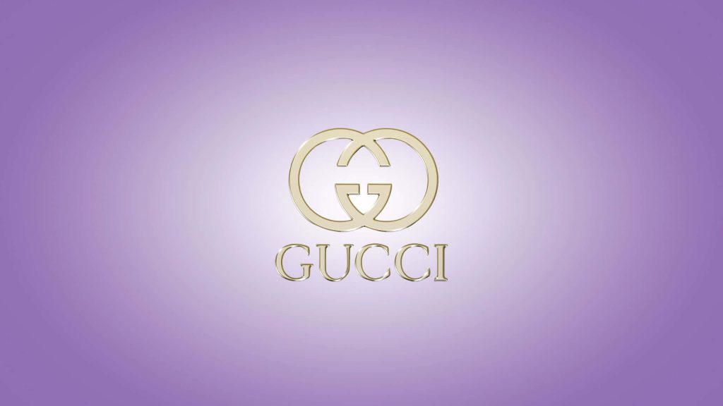 Luxurious Gucci wallpaper with gold interlocking G logo on soft purple gradient background desktop