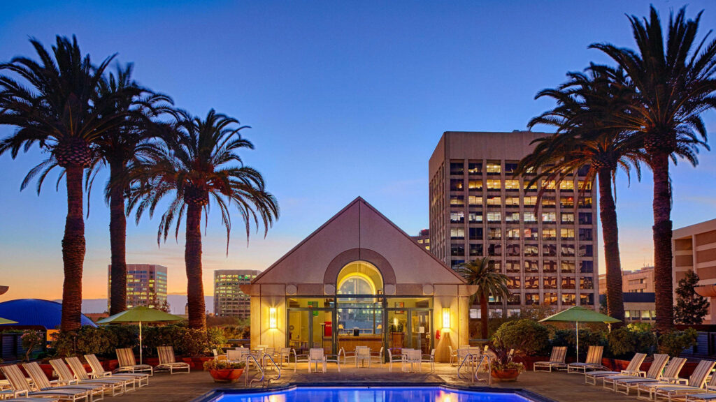Tropical Hotel Pool at Twilight - Luxe Wallpaper Background