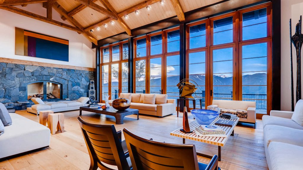 Luxurious living room Zoom background with stone fireplace vaulted ceilings and mountain views Wallpaper
