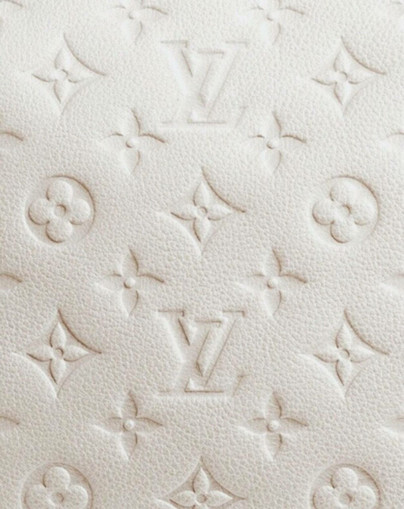 Louis Vuitton white wallpaper with embossed LV monogram and elegant floral pattern background